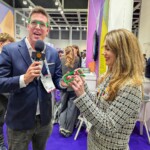 Club GLOBALS team engaging participants with custom green glasses at GITEX.